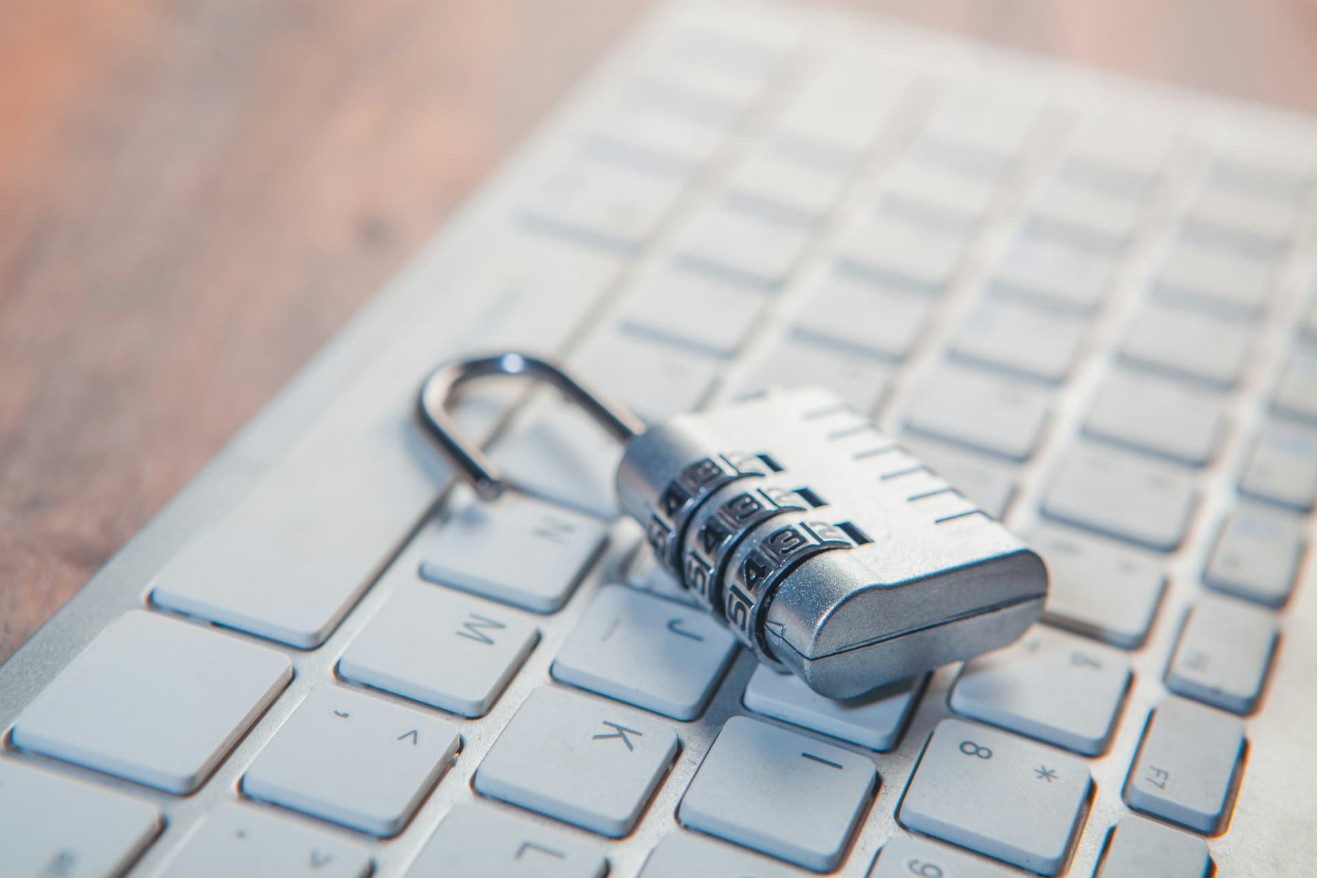 A combination lock resting on a laptop keyboard