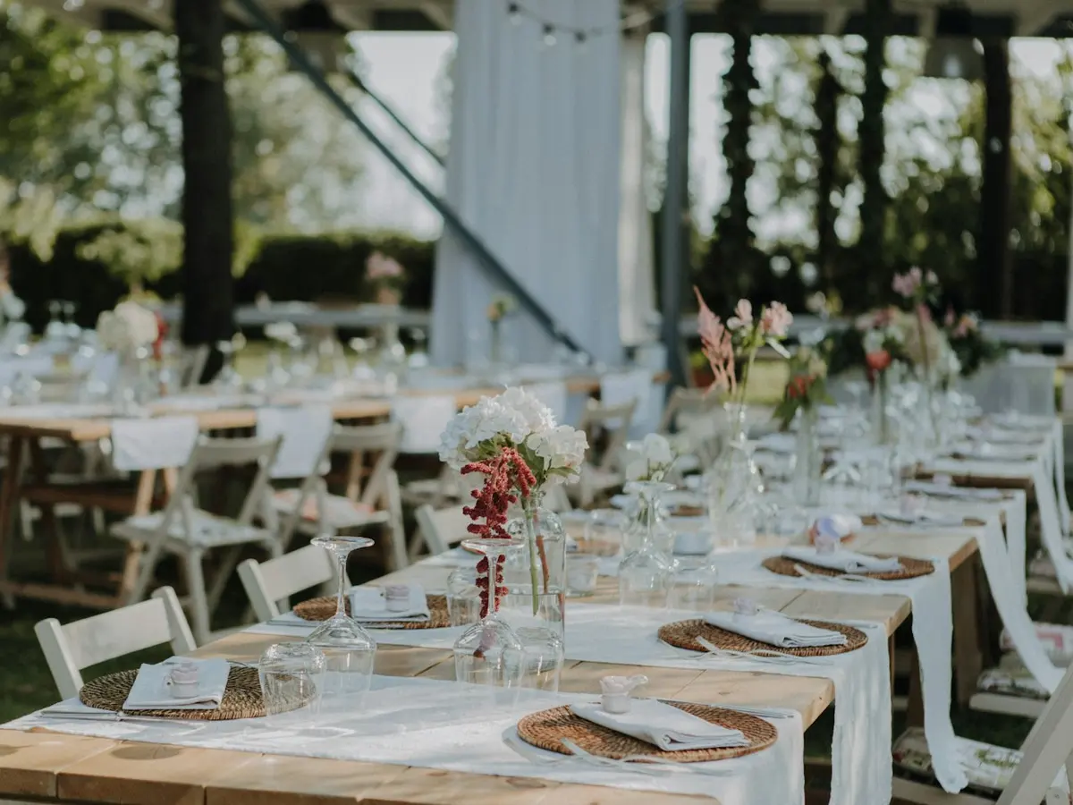 Wedding reception tables set with flowers and glassware