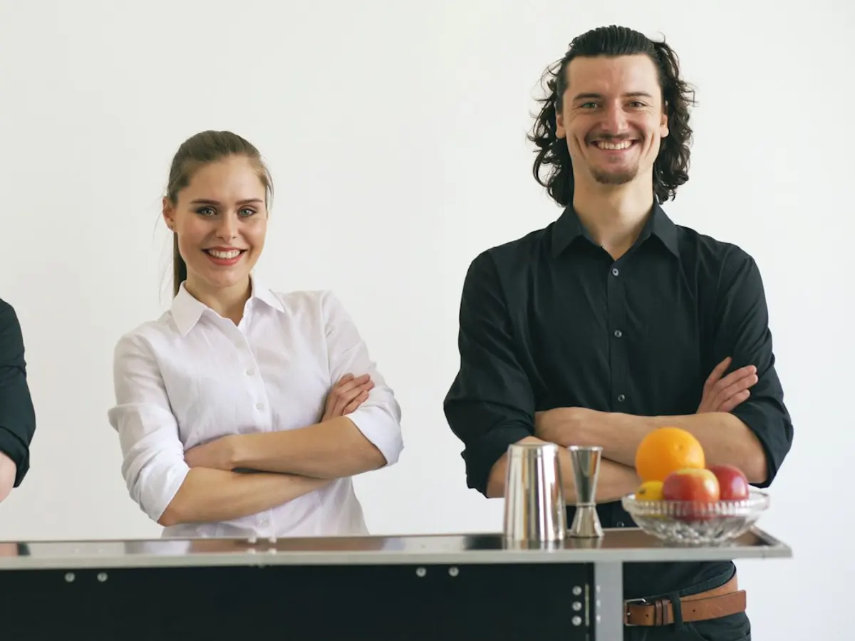 Two members of an event catering team behind a bar