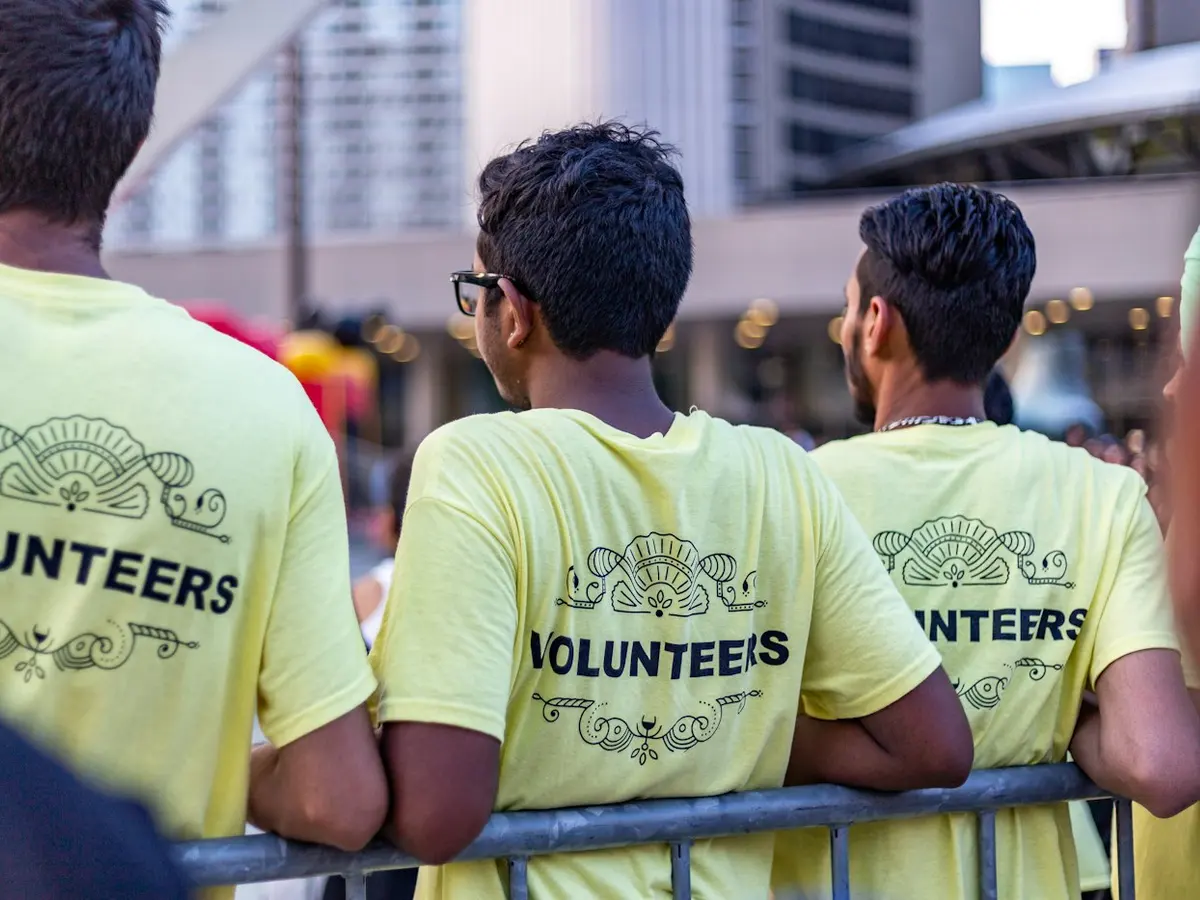 Three volunteers in matching event shirts