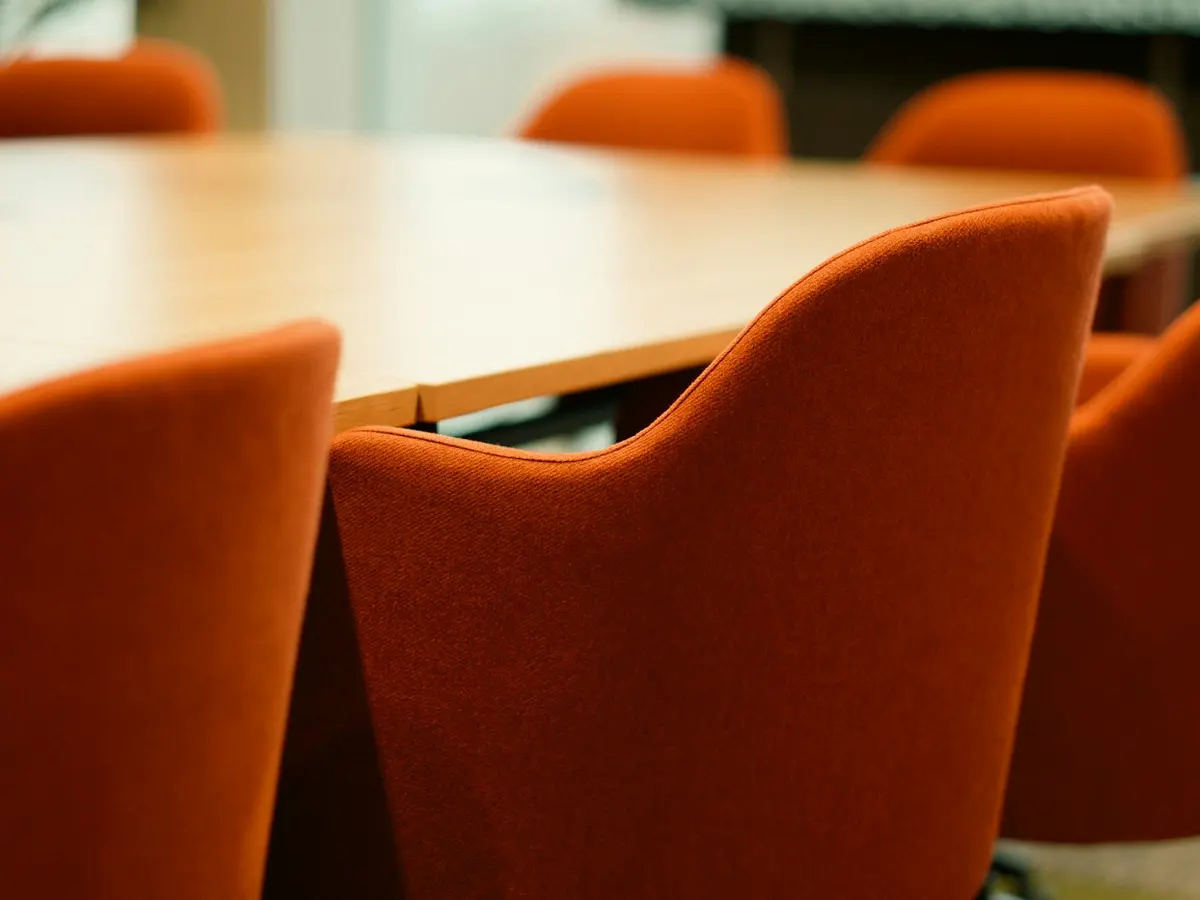 Boardroom table with orange chairs