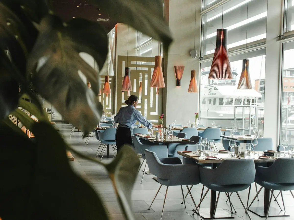 Bright restaurant dining room set for service