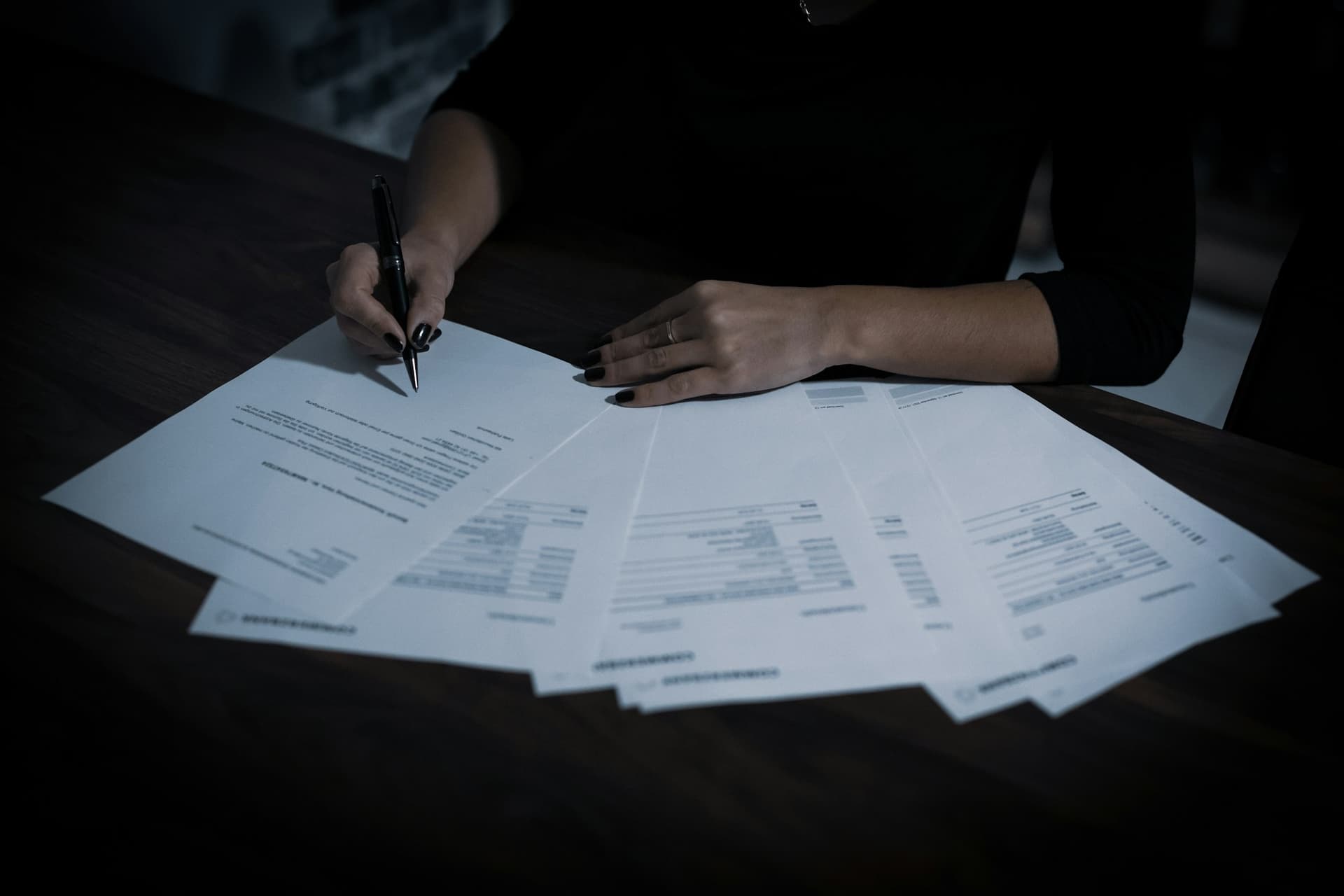 A client's financial records spread across a desk for review before a cleanup quote