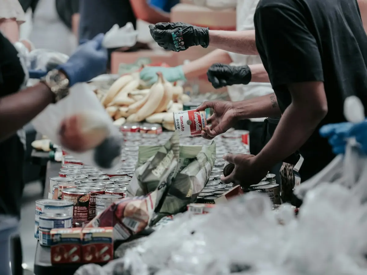 Volunteers sorting donated food at a food bank