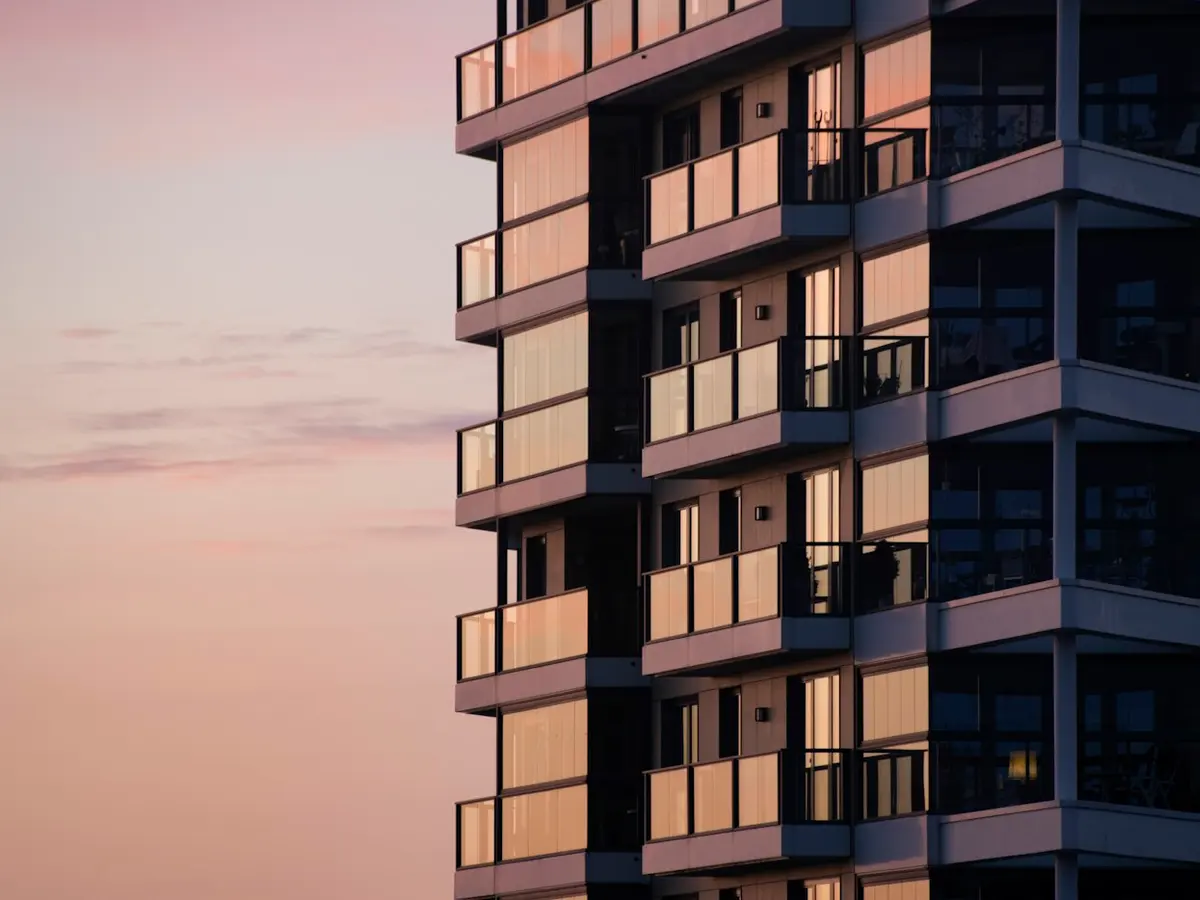 Modern apartment building with balconies at dusk