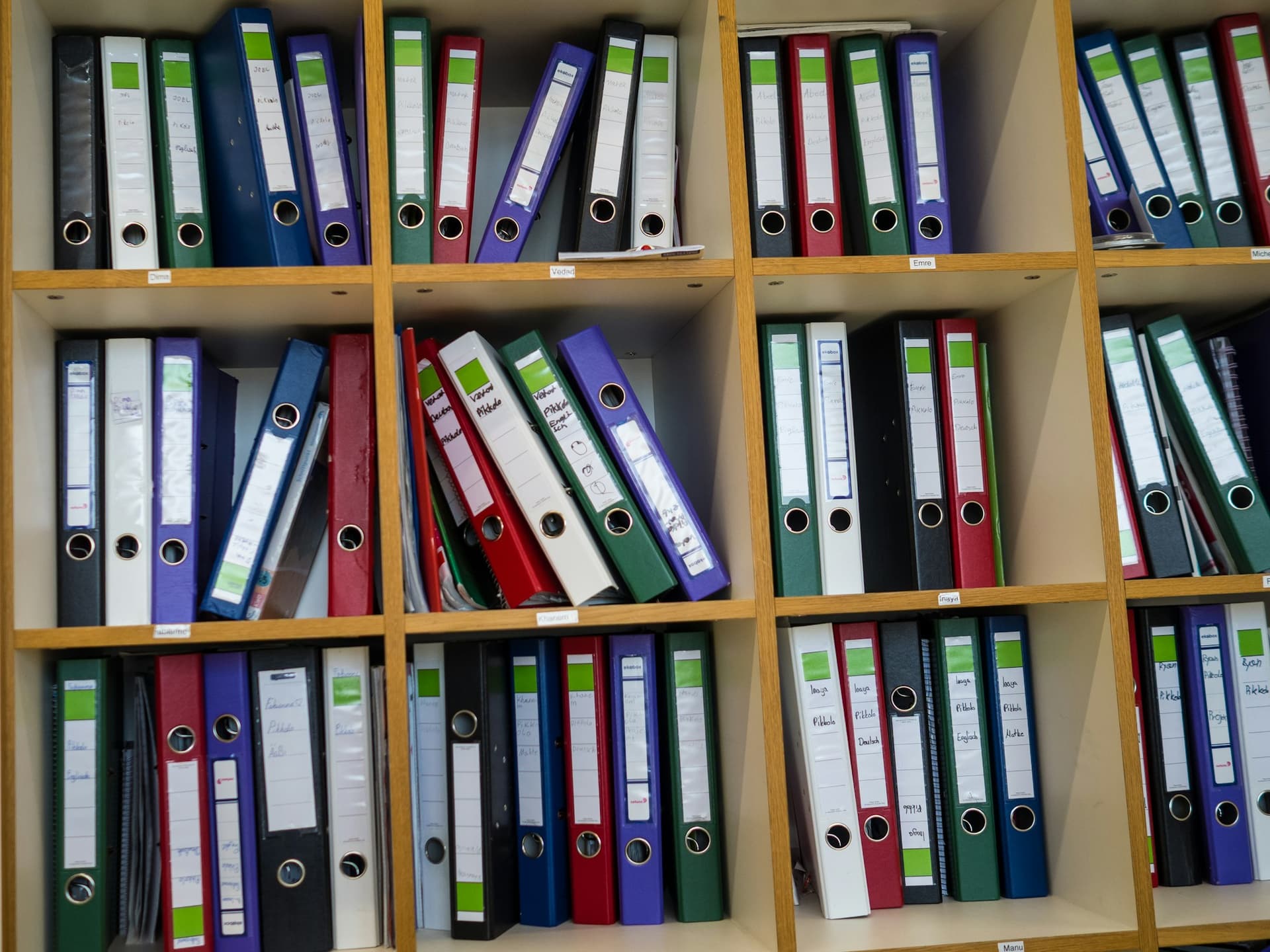 Shelves of labeled ring binders holding financial records